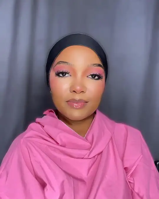 Pink eyeshadow and pink cheeks on a woman in a pink wrap