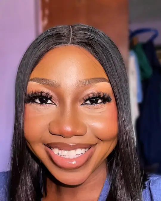 Full lashes and a wide smile, long straight hair